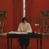 Woman wearing a stylish outfit from The Post House and writing a letter